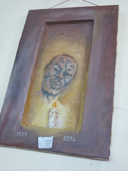 A painting in memory of Roger Mbede hangs in the office of a Cameroonian LGBT organization. (rcb)